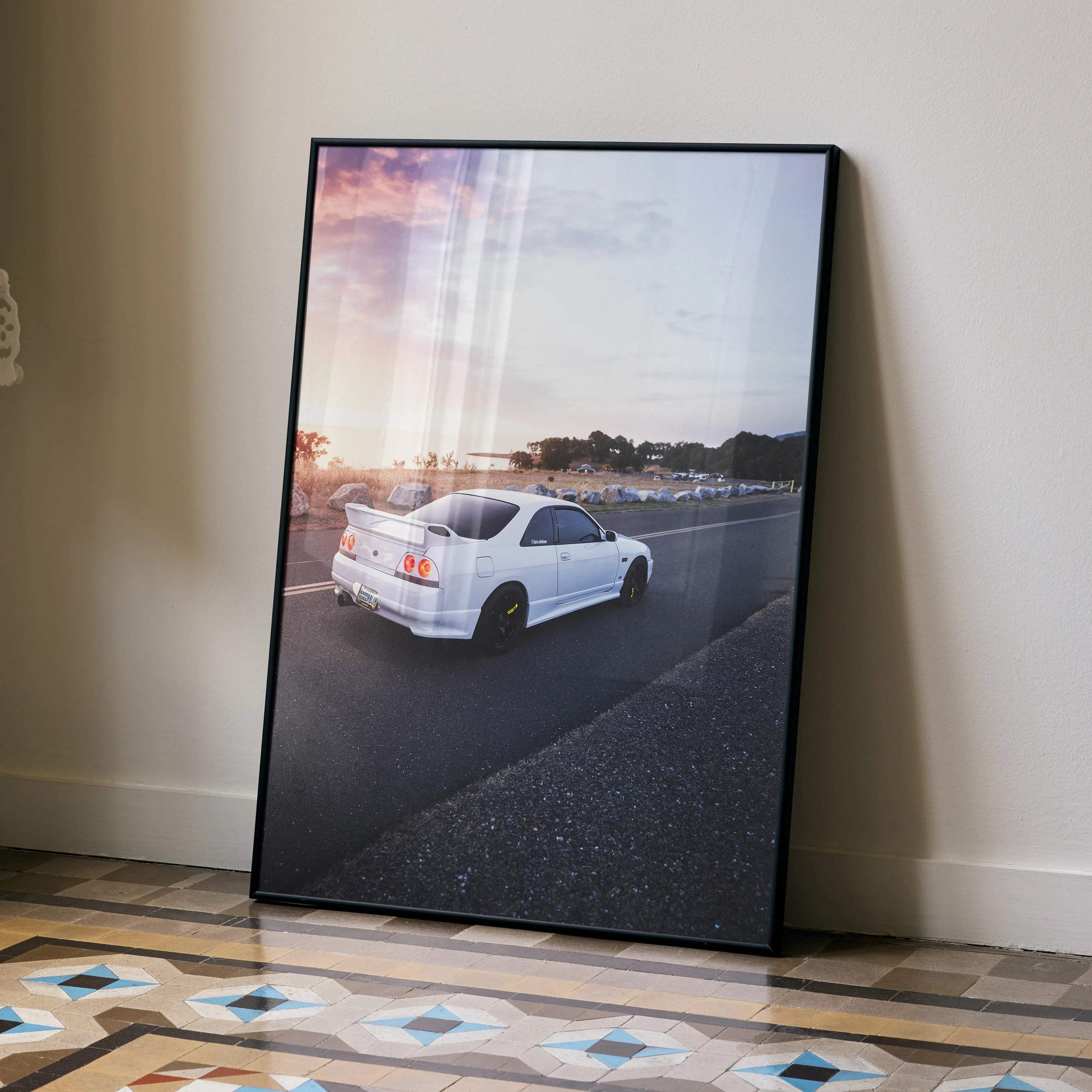 Nissan Skyline R33 GTS-T white car on road at sunset poster wall art in black frame.