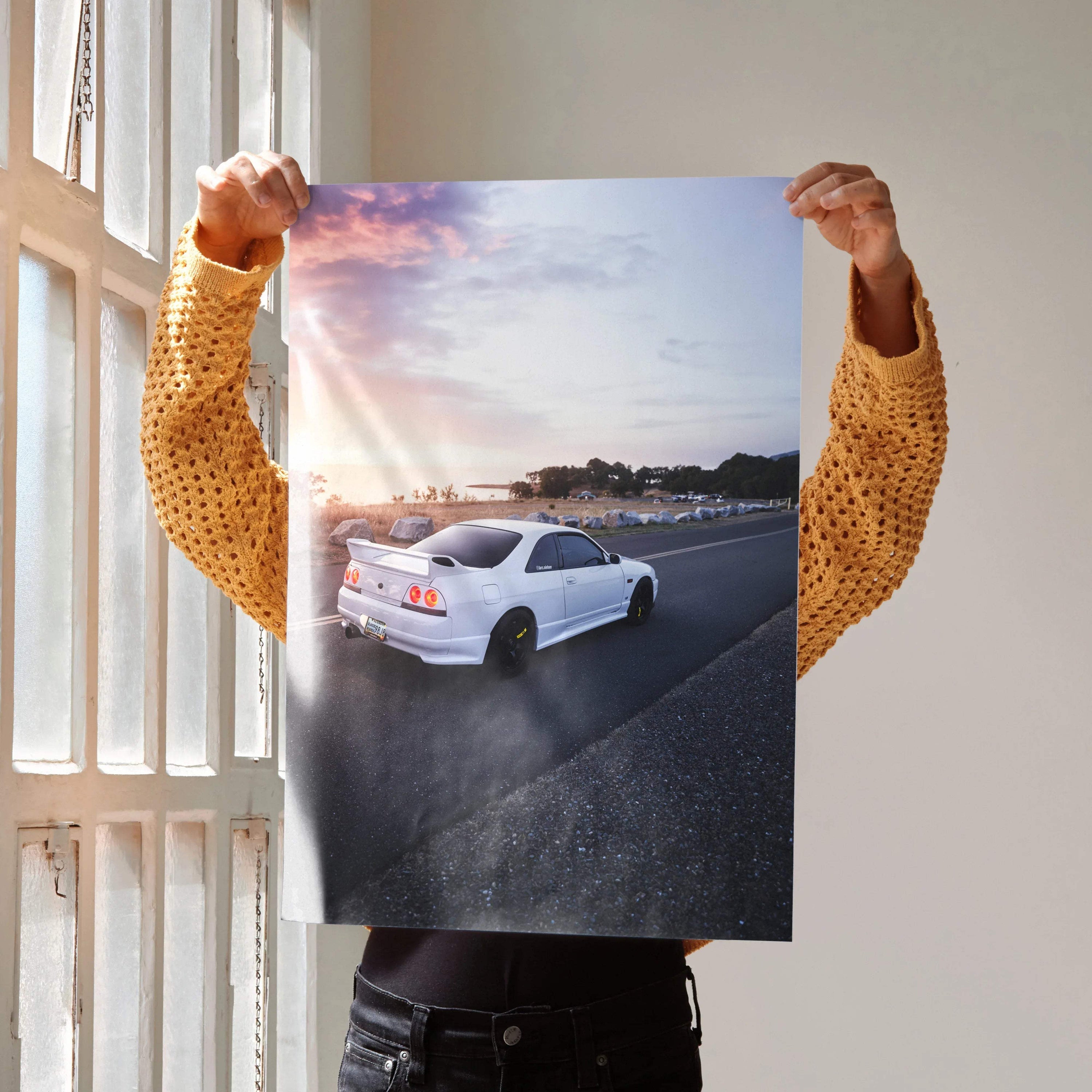 Nissan Skyline R33 GTS-T driving at sunset poster wall art with vibrant sky and road.