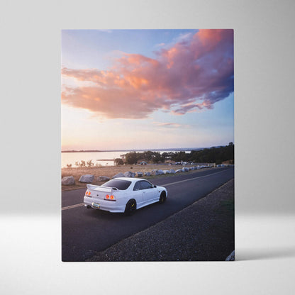 White Nissan R33 GTS-T car parked on coastal road at sunset canvas wall art.