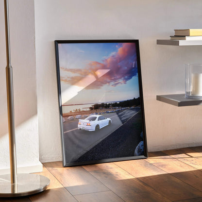Nissan R33 GTS-T driving on highway at sunset poster wall art in black frame.