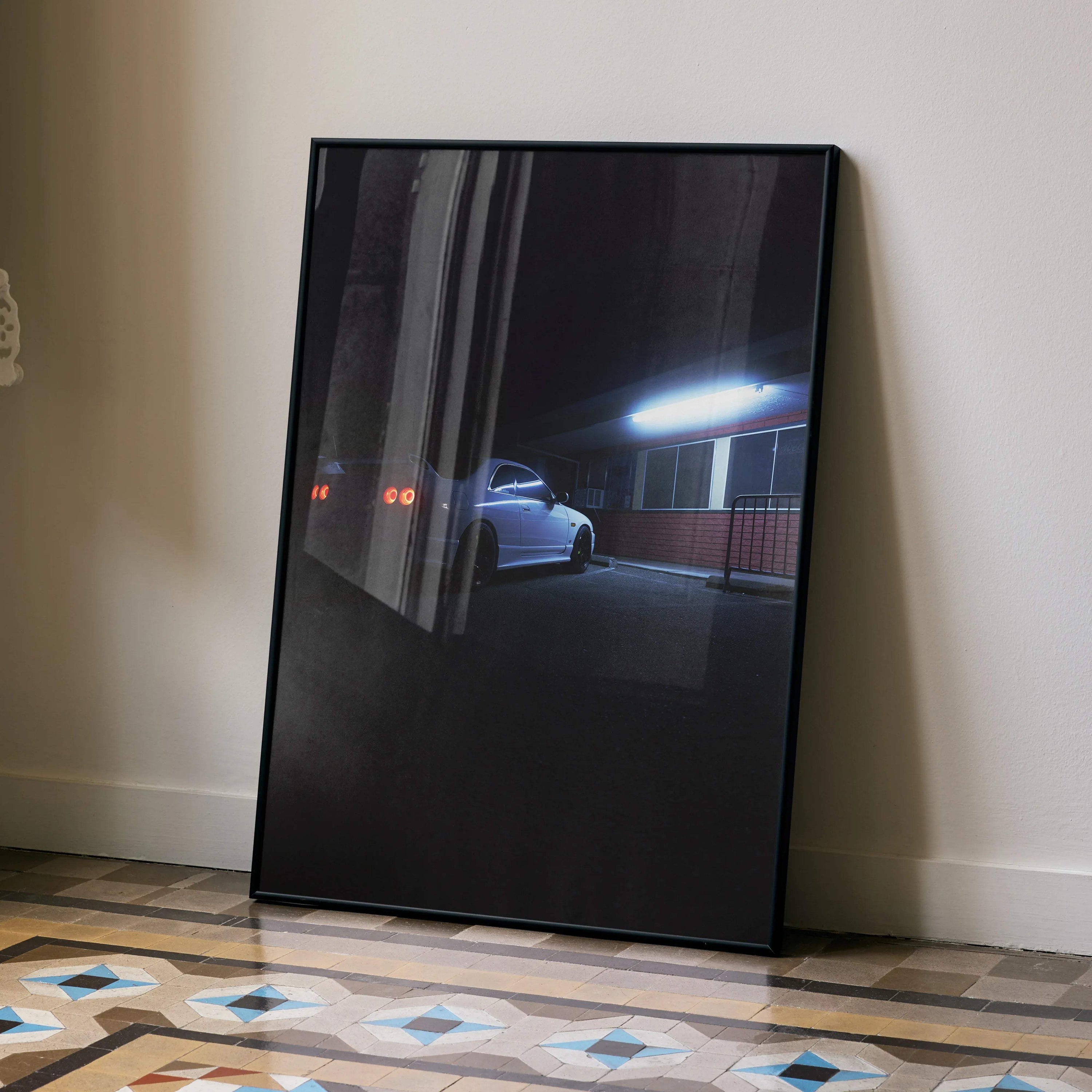 Nissan Skyline R33 GTS-T parked under streetlight at night poster wall art in black frame.