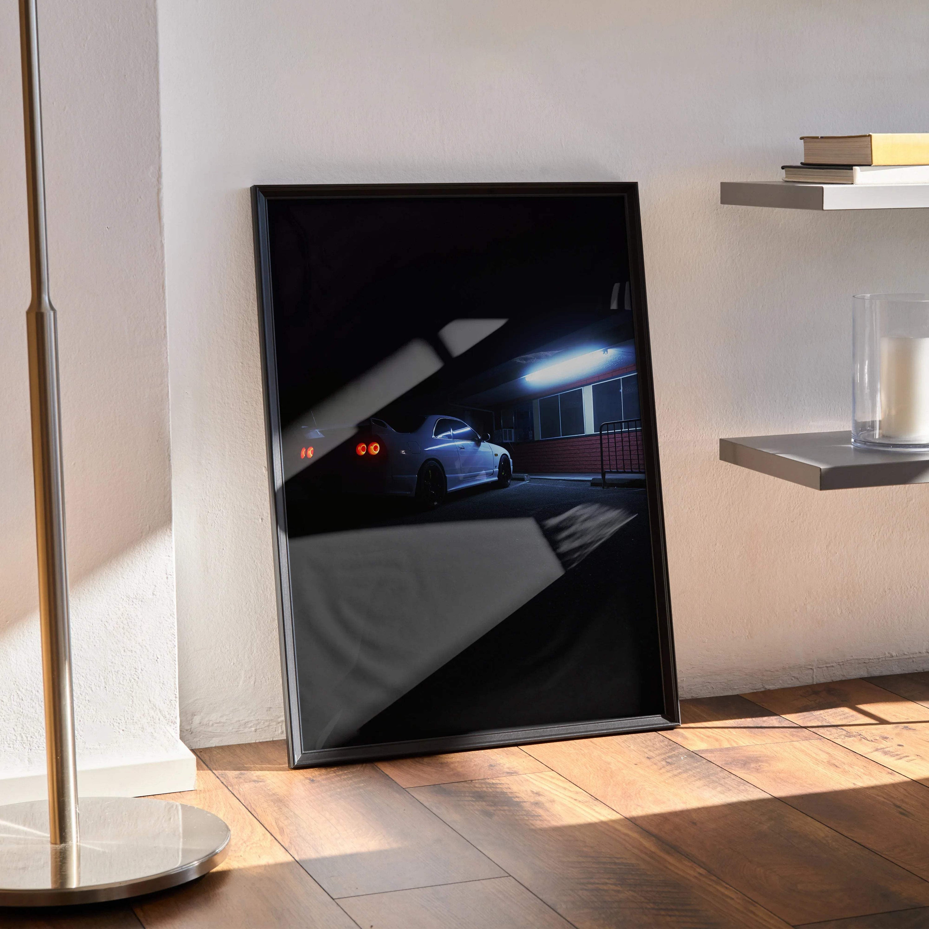Framed Nissan Skyline R33 GTS-T poster in dark nighttime scene, modern wall art display.