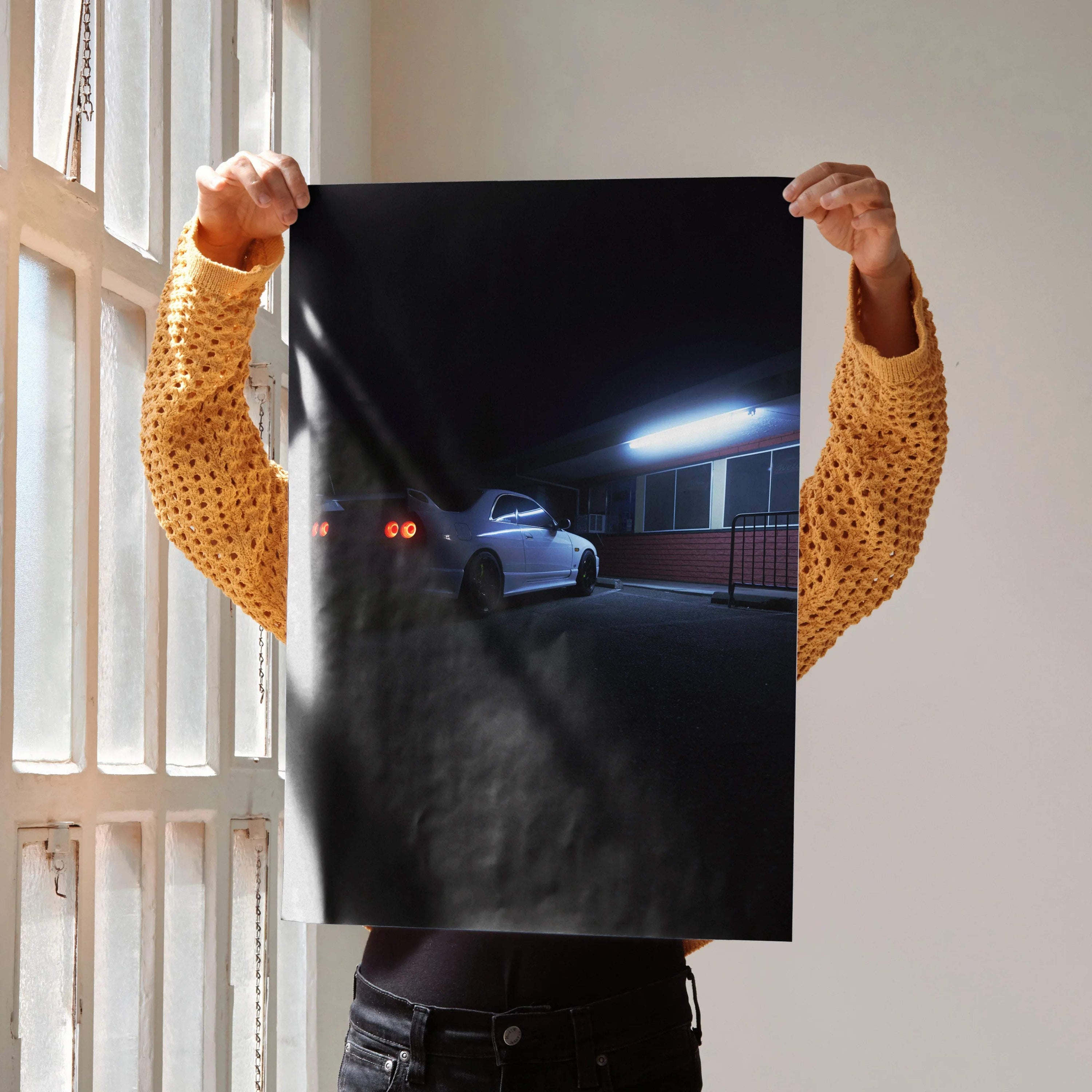 Nissan Skyline R33 GTS-T poster showing rear view of the car at night with glowing taillights, wall art with dark background.