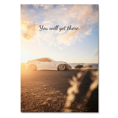 Motivational poster wall art featuring white Nissan 370z at sunset with uplifting text "You will get there.".