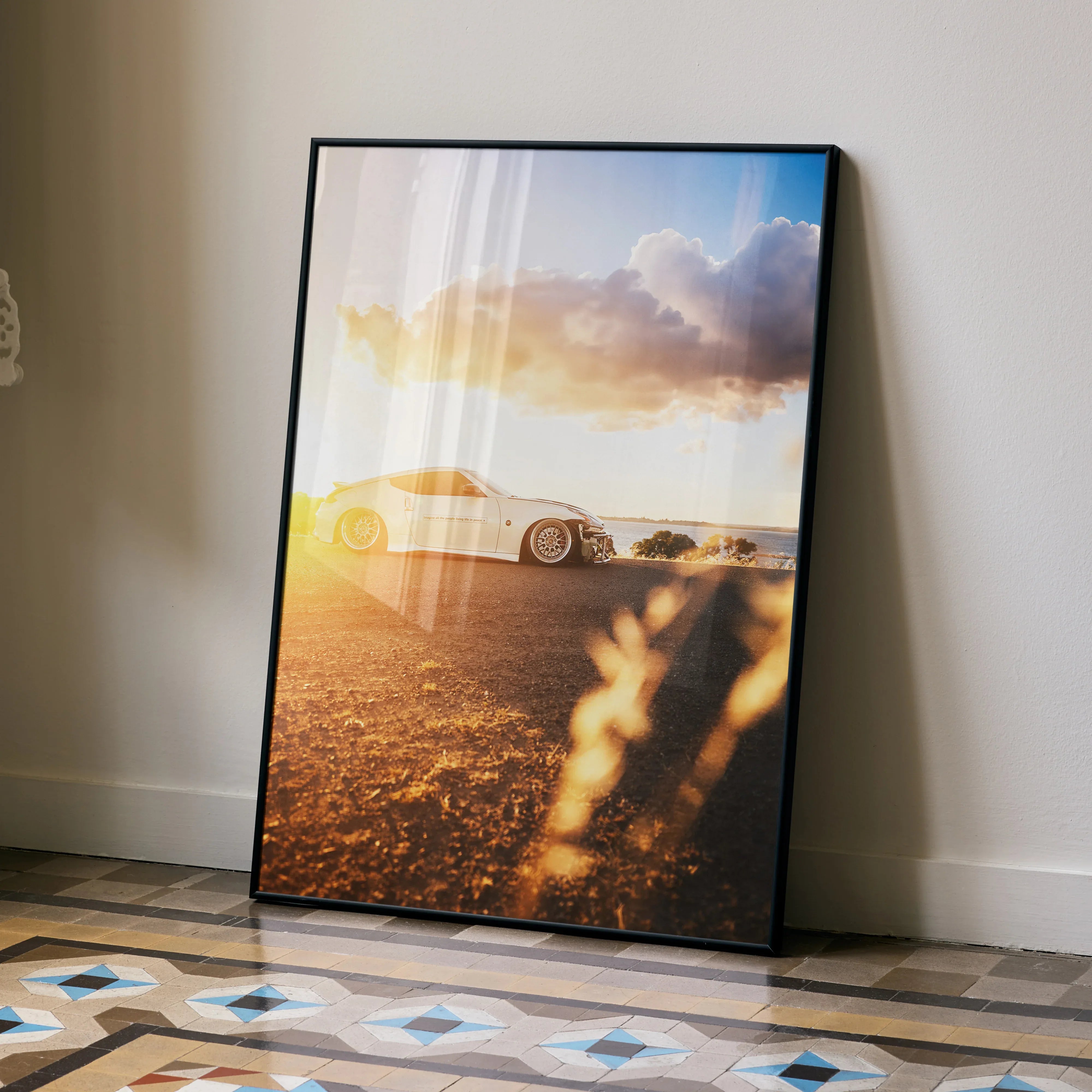 Nissan 370z poster wall art featuring a white sports car at sunset with warm sky tones.