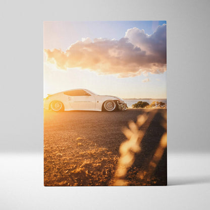 Nissan 370z white sports car at sunset on vertical canvas wall art with warm lighting.