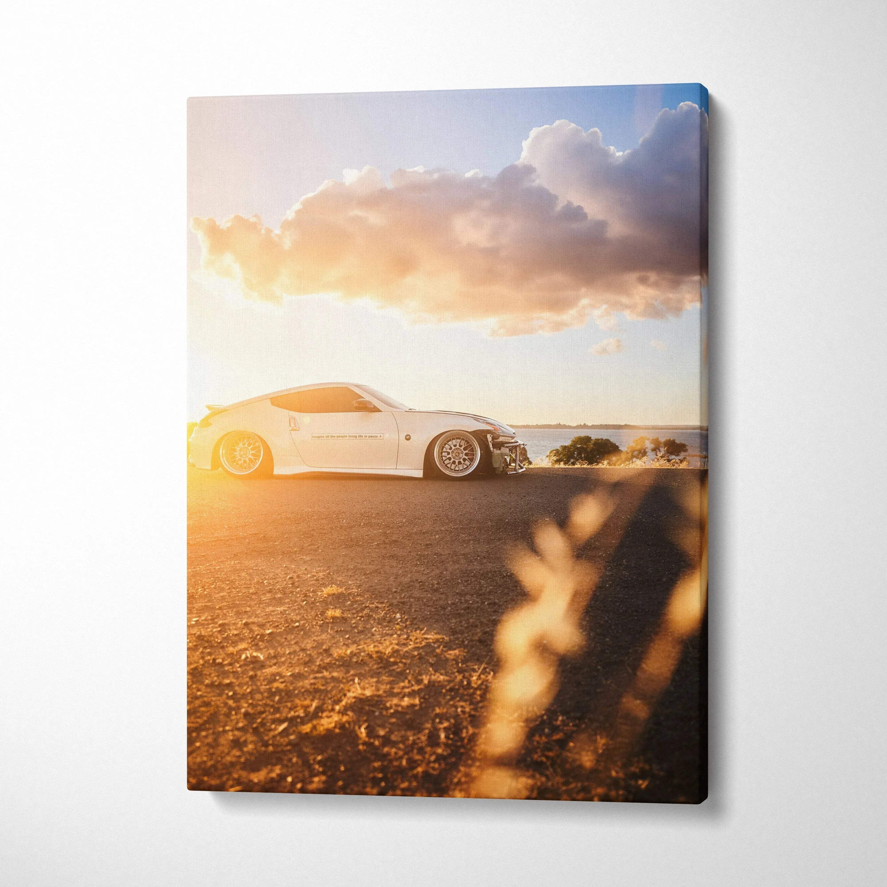 White Nissan 370z sports car at sunset on vertical canvas wall art with warm tones.