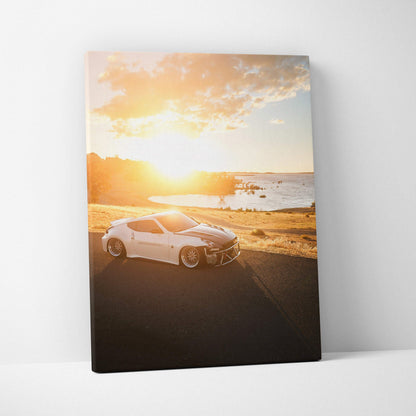 Nissan 370z white sports car on coastal road at sunset vertical canvas wall art.
