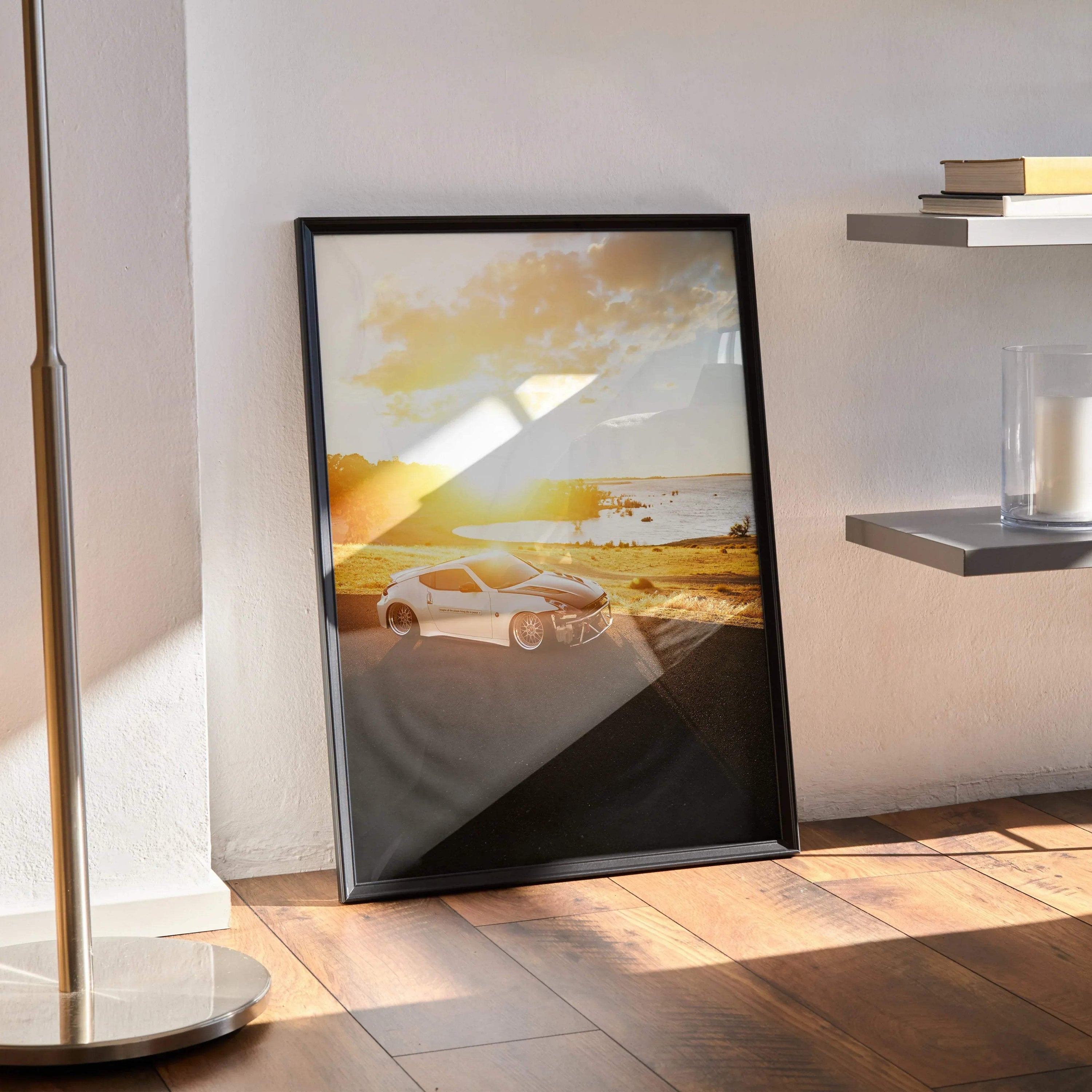Nissan 370z poster wall art in black frame with sunset beach background and sandy shore.