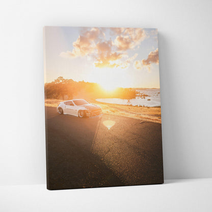Nissan 370z driving on coastal road at sunset vertical canvas wall art.