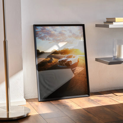 Nissan 370z sports car poster with sunset background framed wall art leaning against white wall.