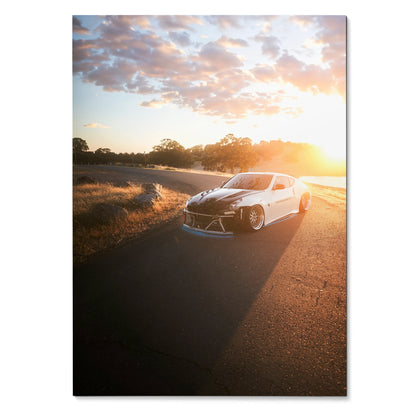 Nissan 370z poster featuring car on road at sunset with dramatic sky, wall art for automotive fans.