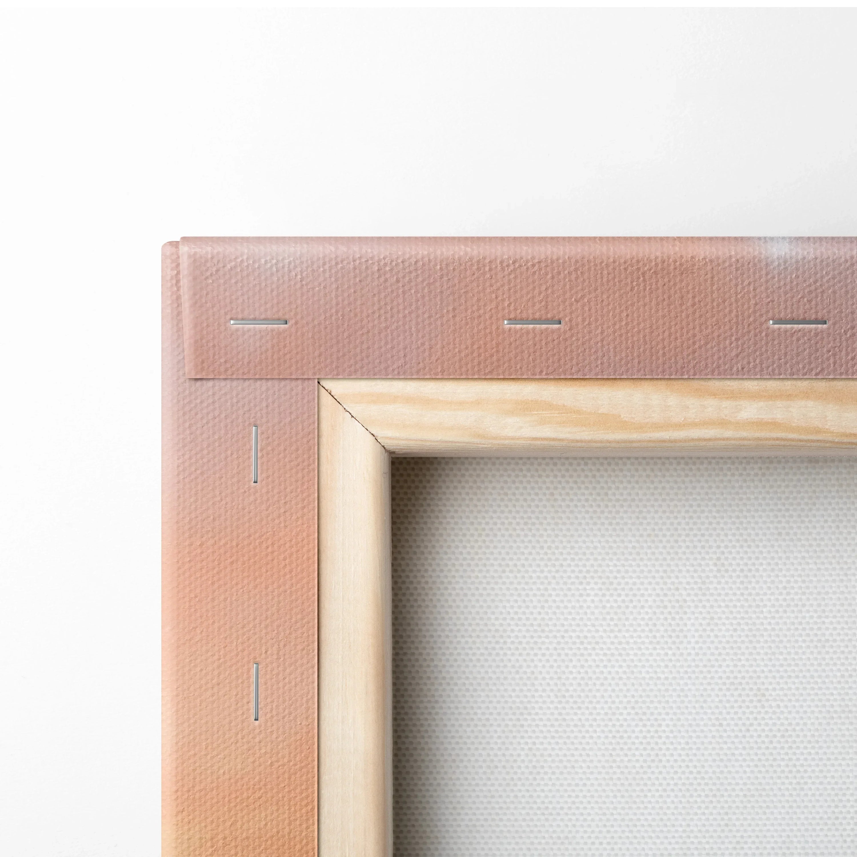 Close-up of wooden frame corner with beige canvas stretched and stapled, gallery-style canvas art wall art.