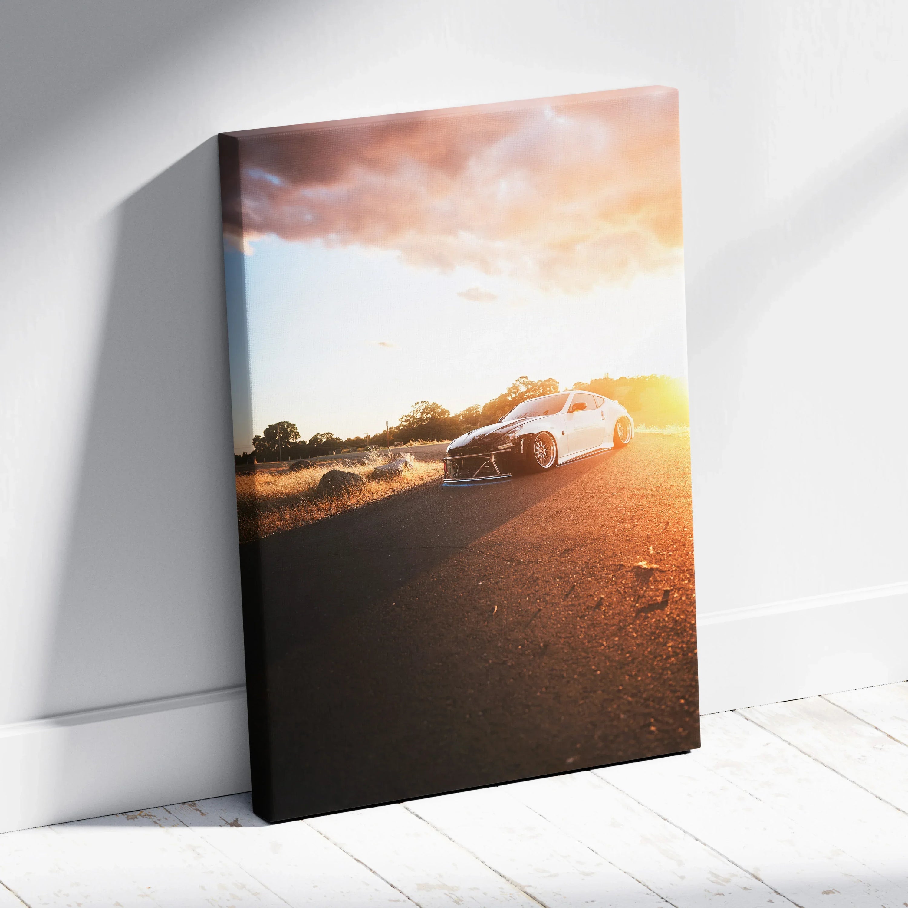 Nissan 370z speeding on road at sunset canvas wall art with vibrant orange sky.