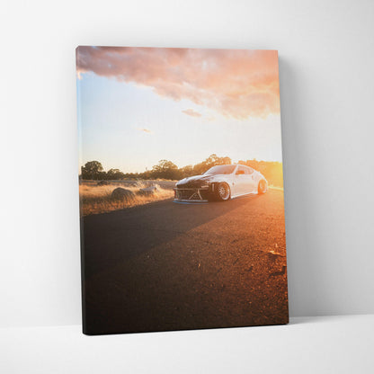 Nissan 370z driving at sunset on road high-resolution vertical canvas wall art.