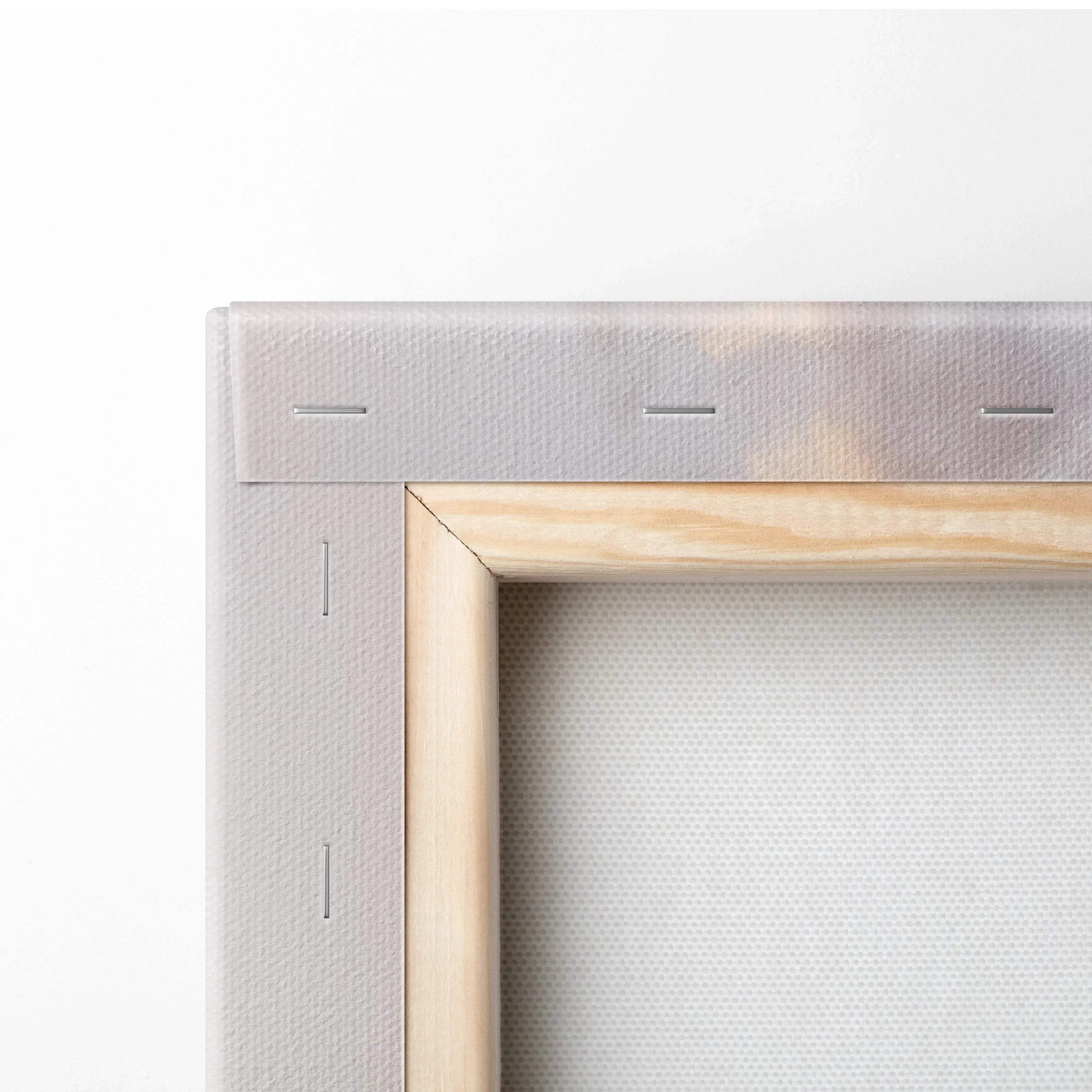 Close-up of stretched canvas corner with wooden frame and stapled edge for wall art display.
