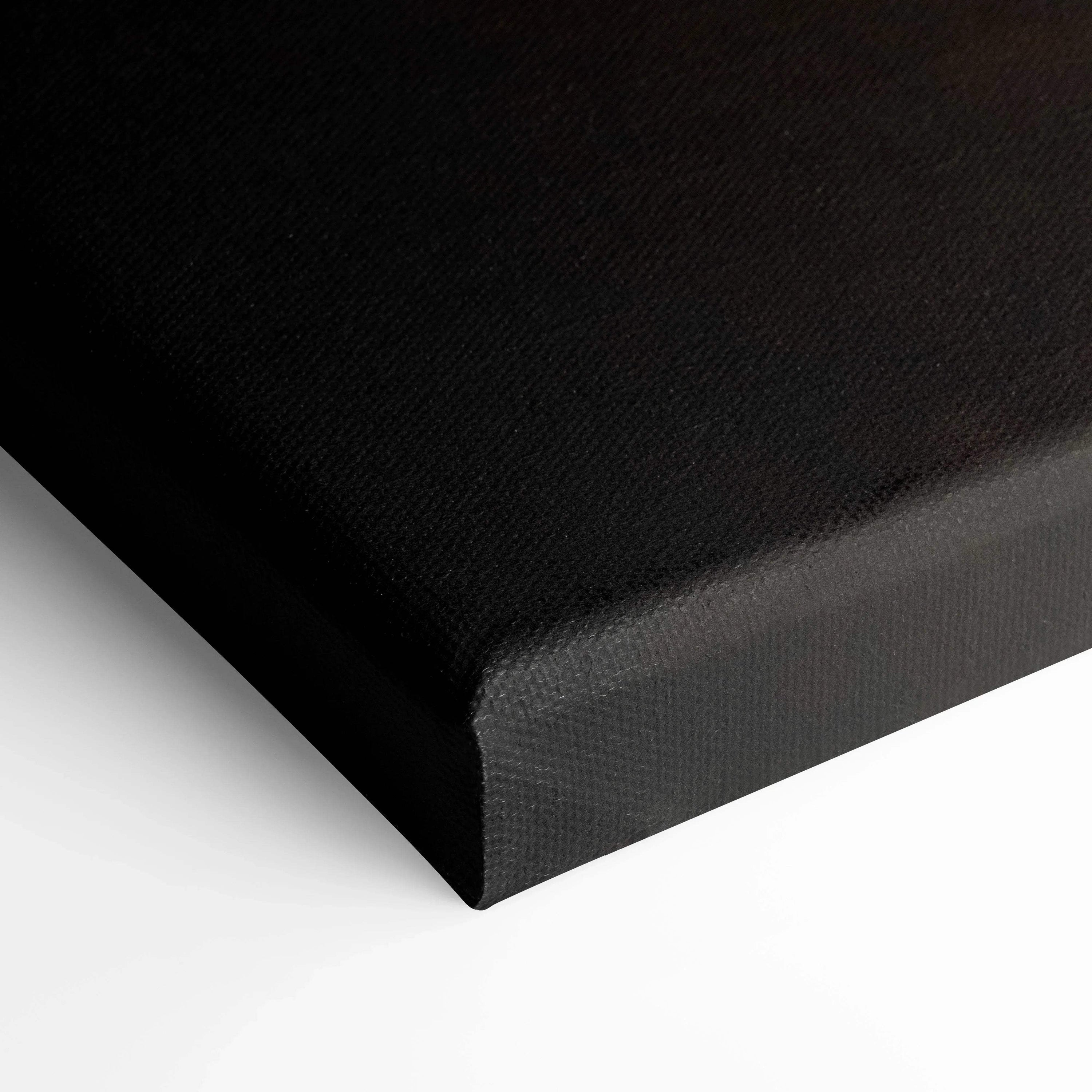 Black wrapped edge canvas wall art close-up showing textured canvas material and sharp corner.