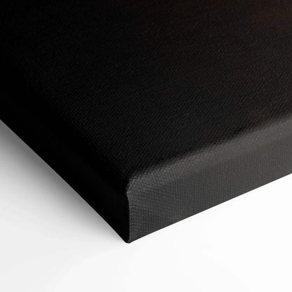 Black wrapped edge canvas wall art close-up showing textured canvas material and sharp corner.