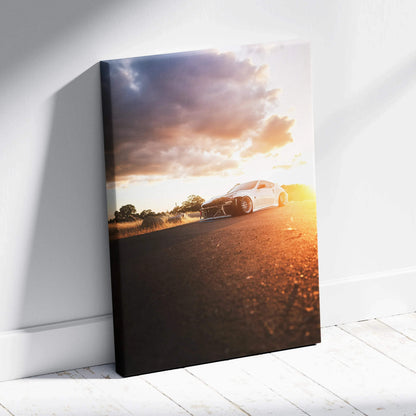 Nissan 370z on road at sunset canvas wall art with vibrant sky and warm lighting.