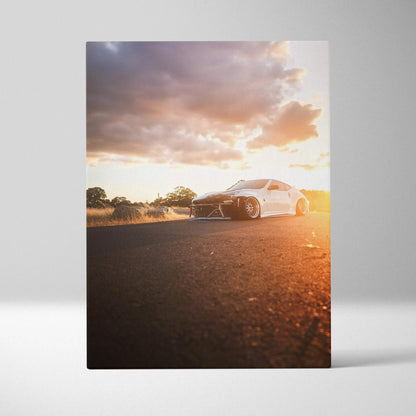 Vertical canvas wall art of white Nissan 370z on road at sunset with dramatic sky.