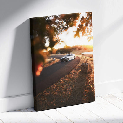 Nissan 370z driving on curved road at sunset canvas wall art with warm tones and detailed shadows.