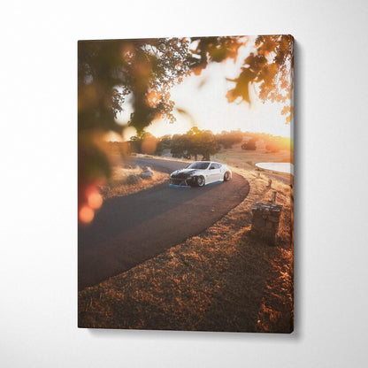 Nissan 370z driving on winding road at sunset canvas wall art with warm autumn tones.