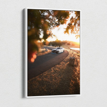 Vertical canvas wall art featuring a white Nissan 370z on a winding road at sunset with warm autumn tones.