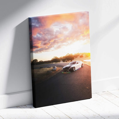 Vertical canvas art of a white Nissan 370z on a road at sunset with colorful sky wall art.