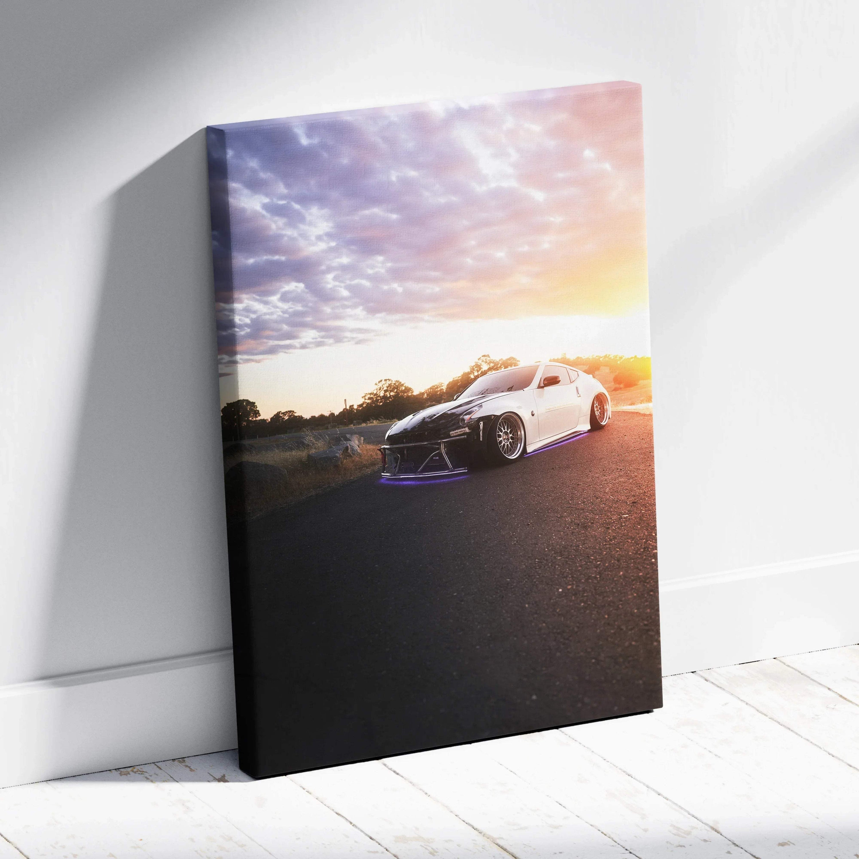 Vertical canvas wall art featuring a white Nissan 370z at sunset with vibrant sky colors.