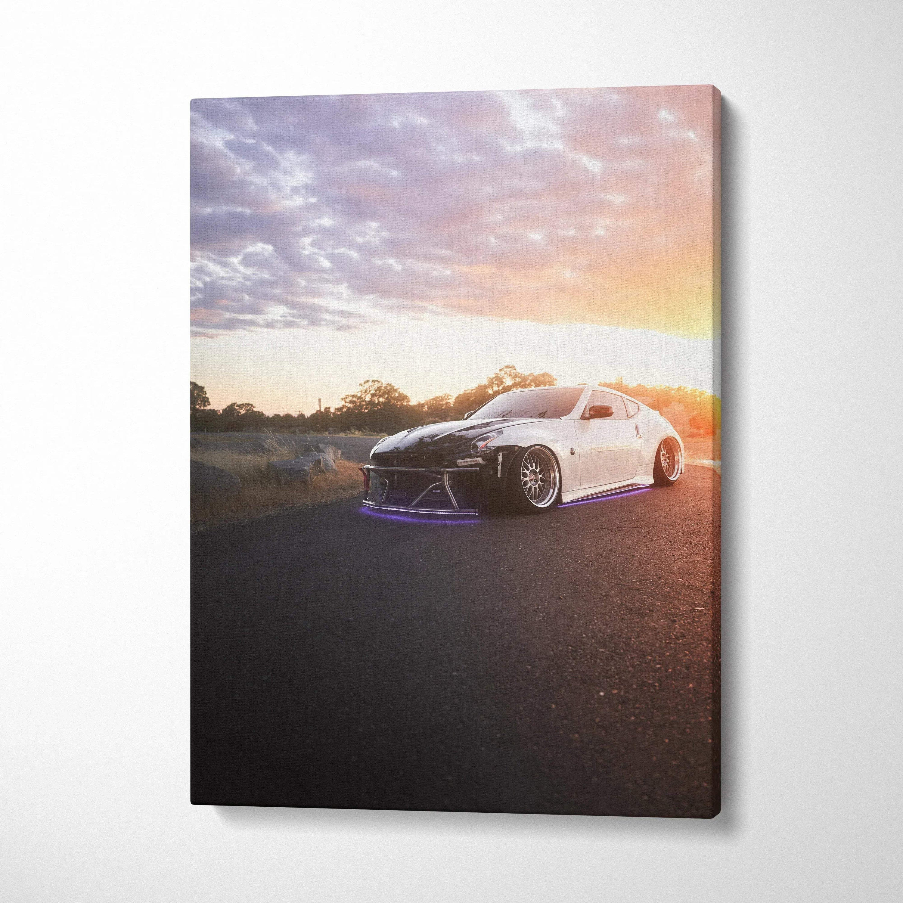 Nissan 370z at sunset on asphalt road canvas wall art with vibrant sky colors.