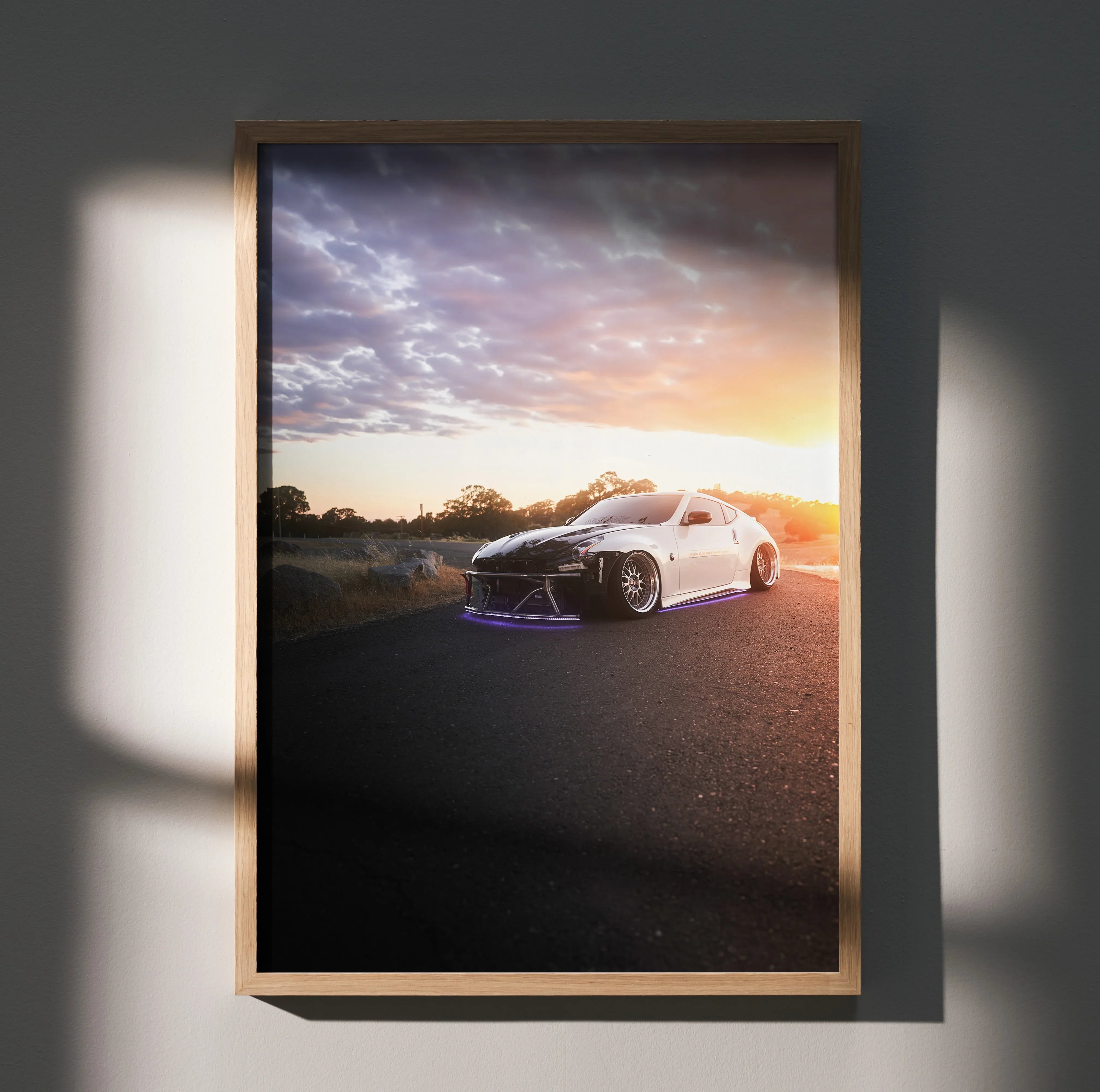 Nissan 370z car at sunset on road poster wall art in wooden frame.