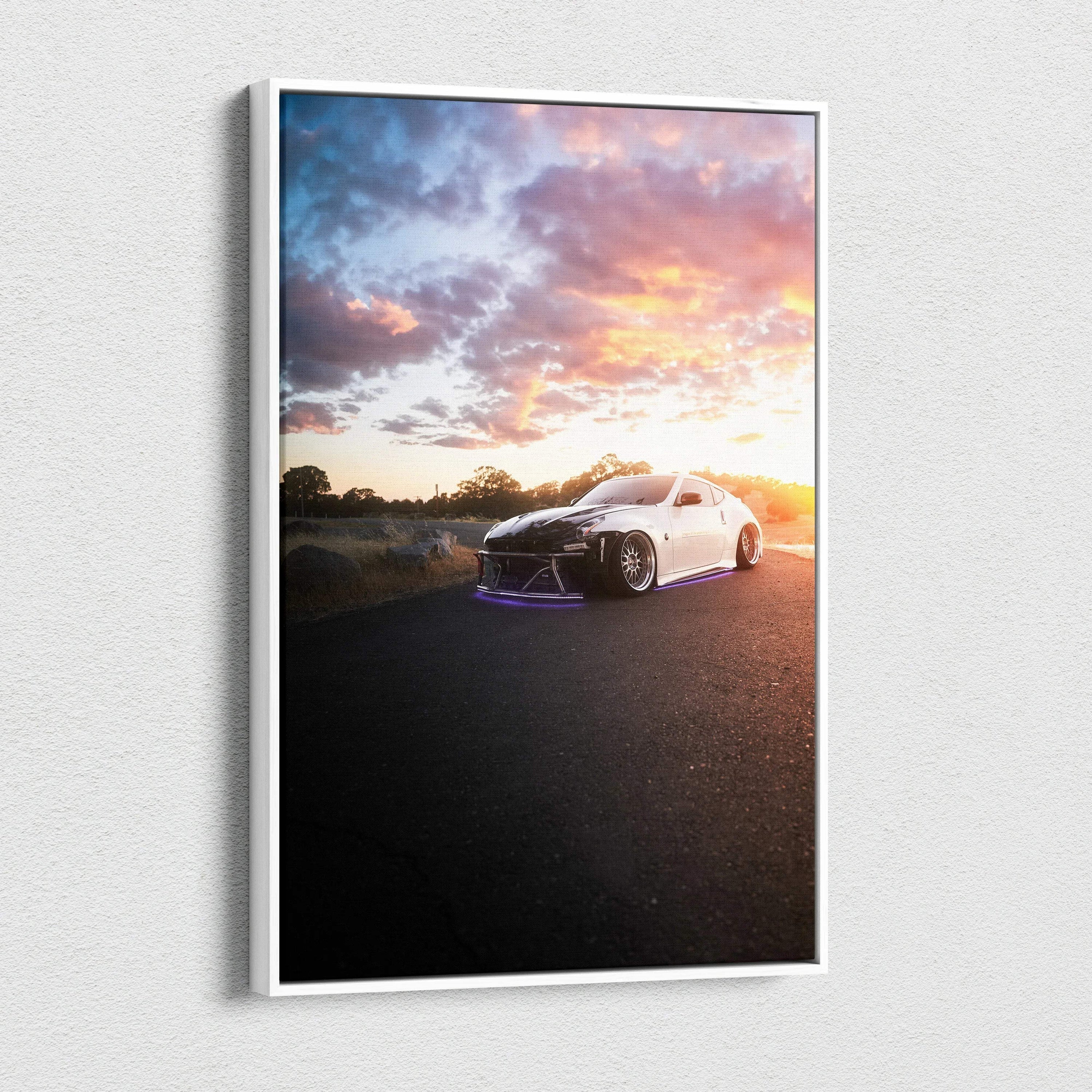 White Nissan 370z on road at sunset with vibrant sky, vertical canvas wall art print.