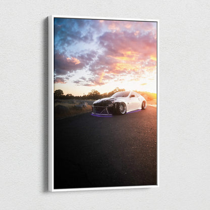 White Nissan 370z on road at sunset with vibrant sky, vertical canvas wall art print.