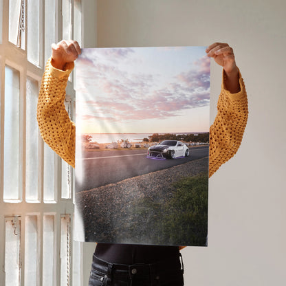 Nissan 370z car poster showing white sports car on road at sunset, wall art with vibrant sky colors.