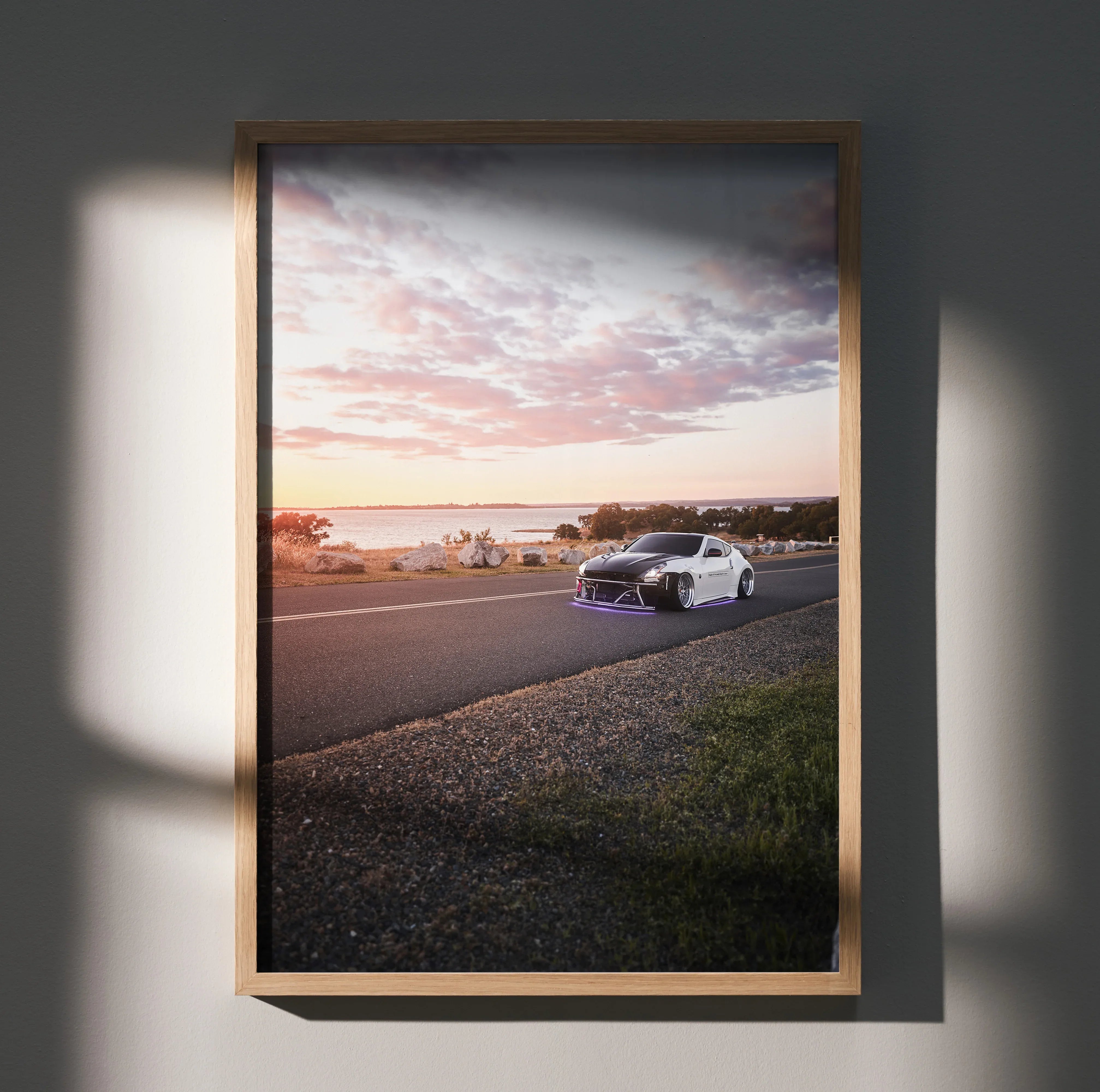 Nissan 370z car driving at sunset on road poster wall art in wooden frame.