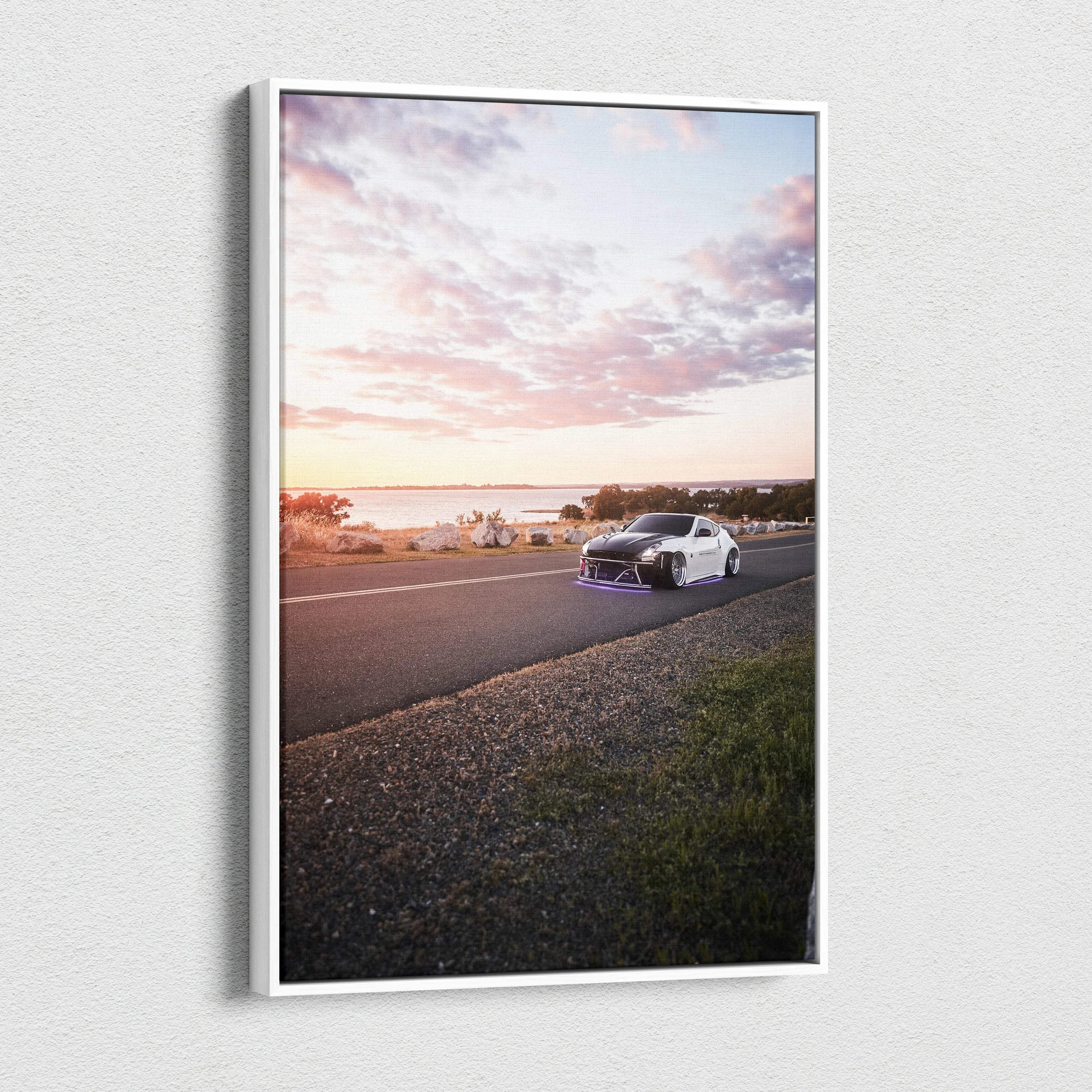 Nissan 370z driving on coastal road at sunset canvas wall art with vivid sky colors.