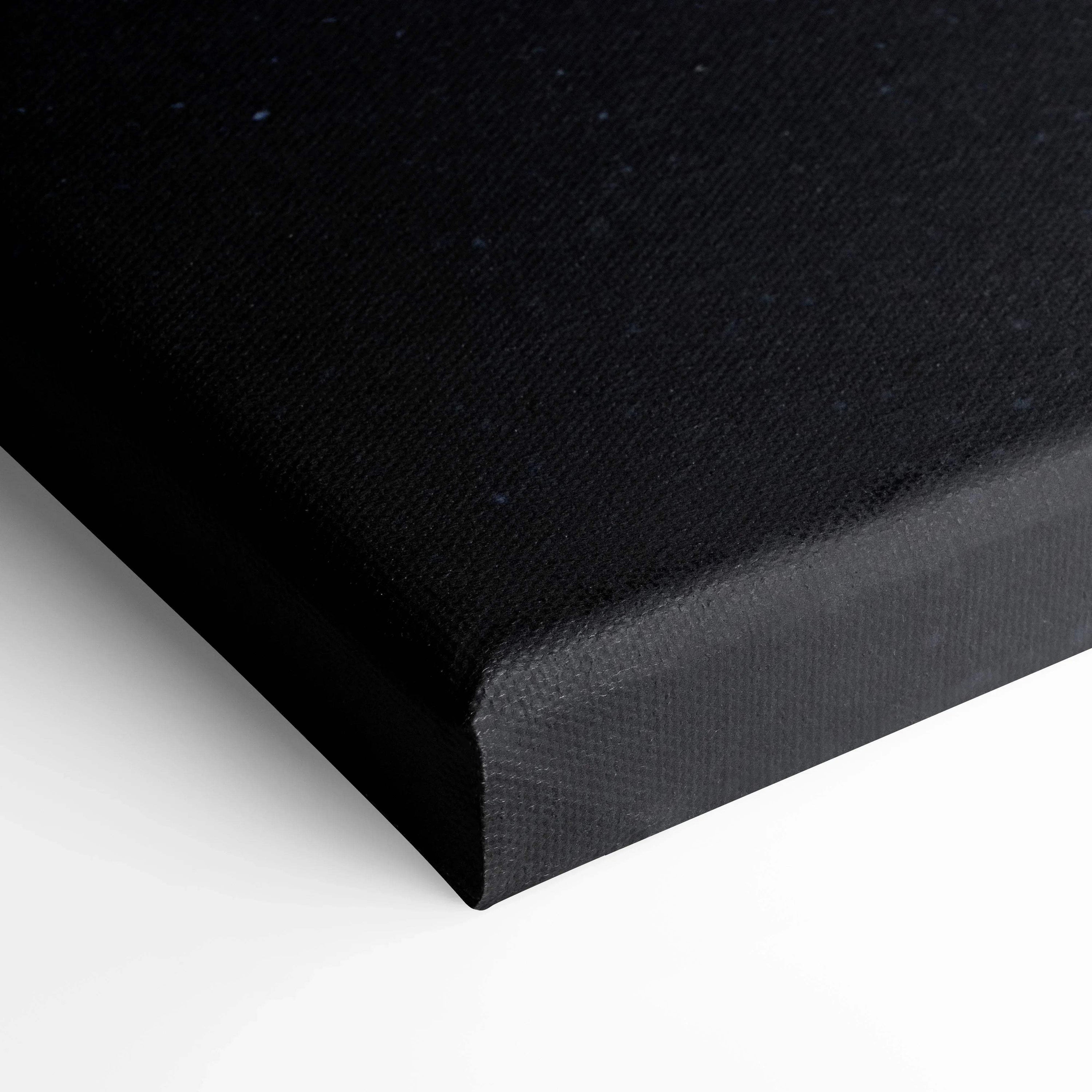 Black stretched canvas corner showcasing texture and tight corner fold for wall art display.