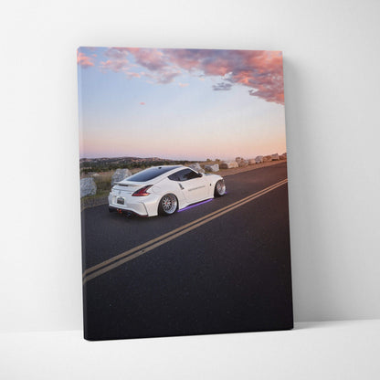 Nissan 370z white sports car on road vertical canvas wall art with sunset sky.