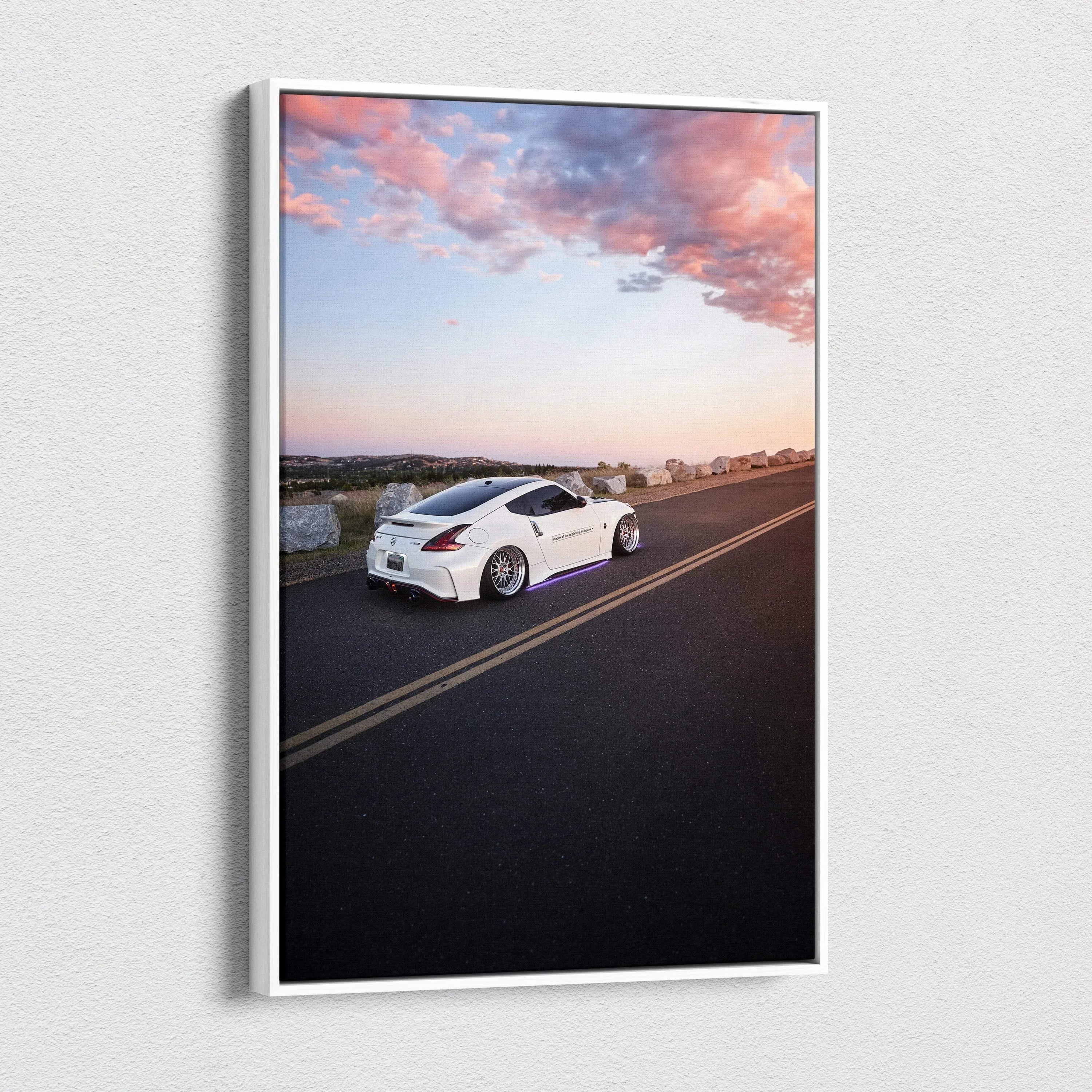 Vertical canvas art featuring a white Nissan 370z on an open road at sunset, vibrant sky colors.