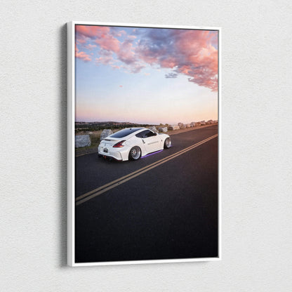 Vertical canvas art featuring a white Nissan 370z on an open road at sunset, vibrant sky colors.