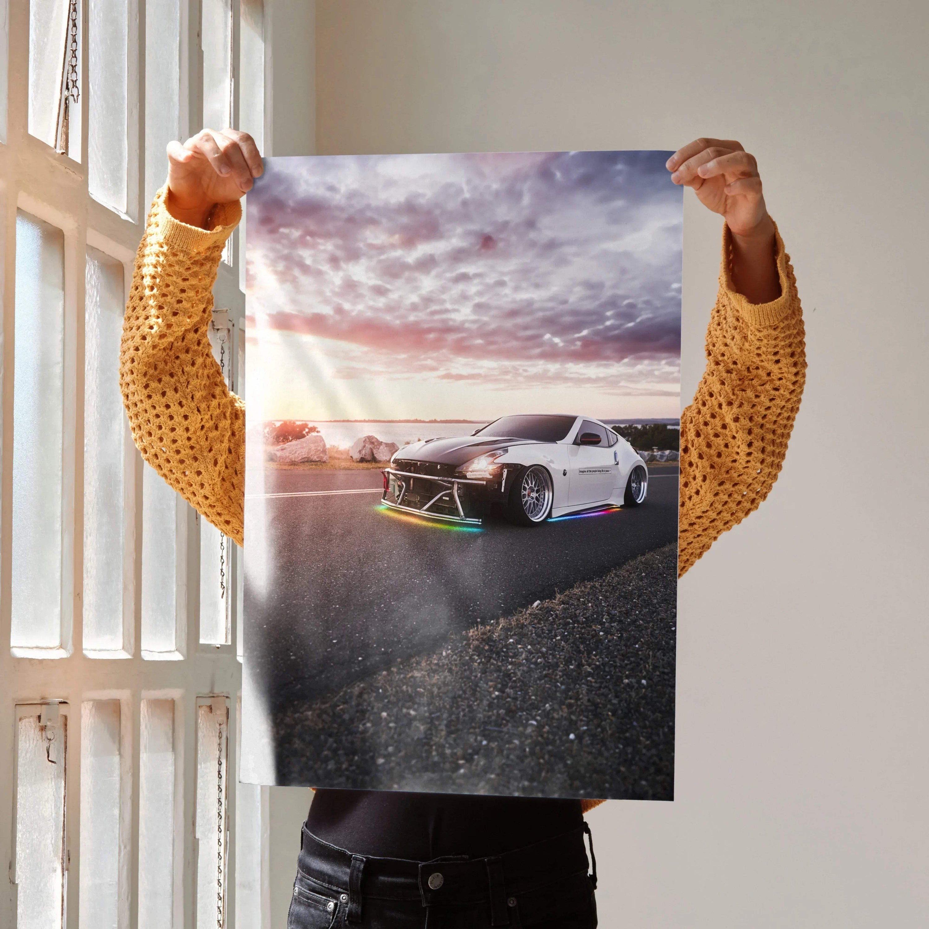 Nissan 370z sports car on road at sunset poster wall art with dramatic sky background.