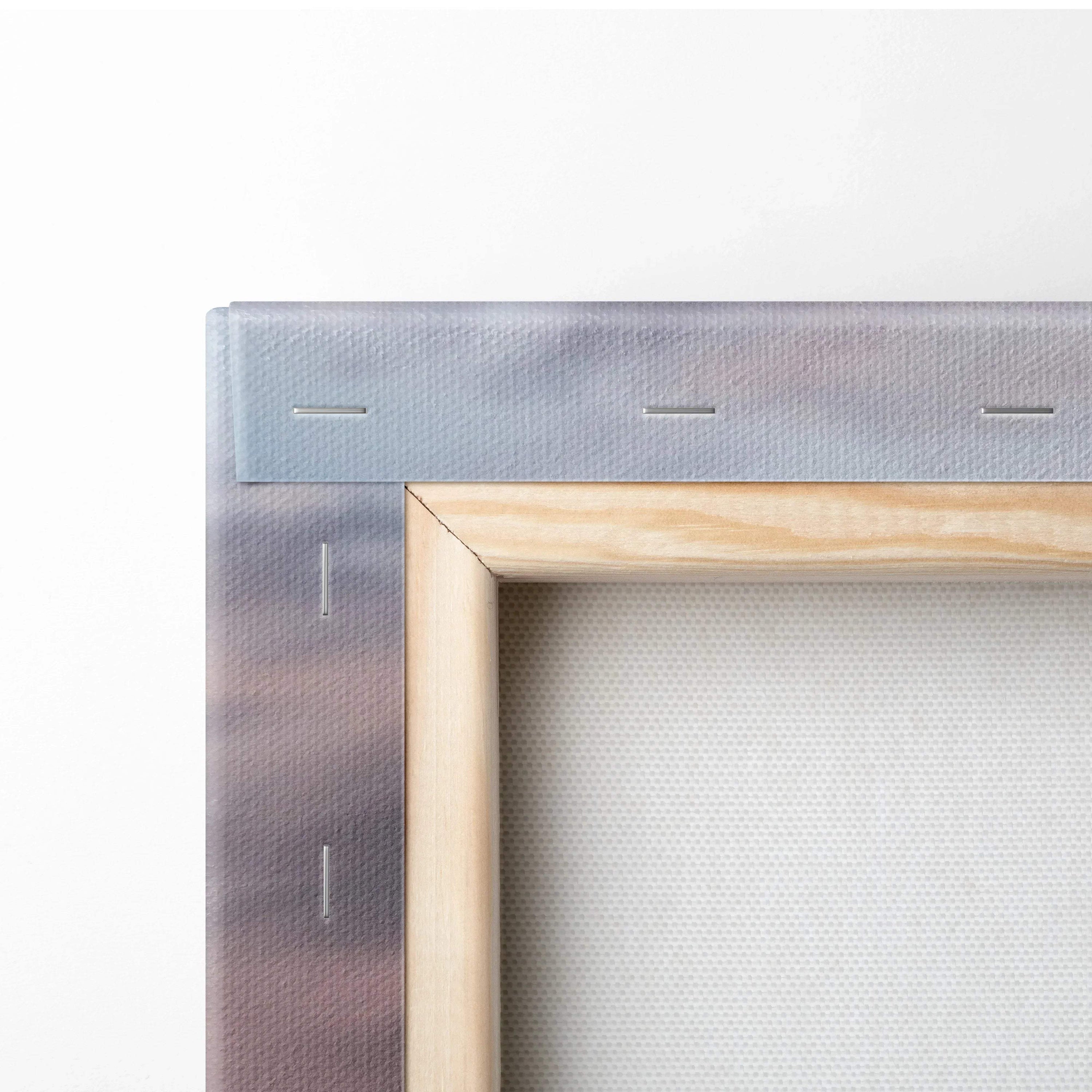 Close-up of stretched canvas fabric on wooden frame with metal stapled edges for wall art canvas print.
