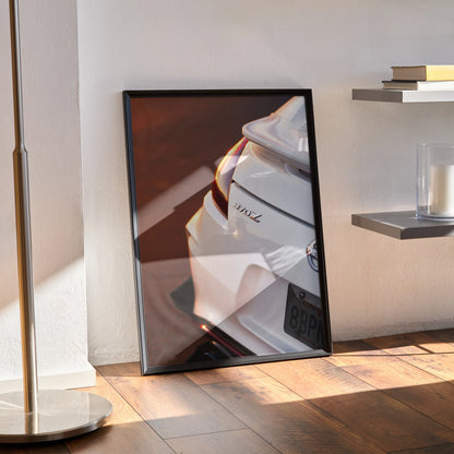 Nissan 370z rear close-up poster wall art in sleek black frame leaning against wall.