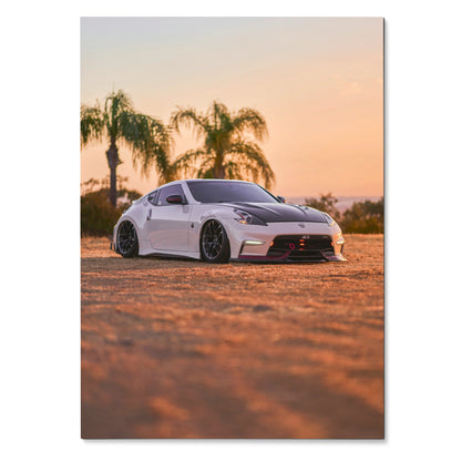 White Nissan 370z on dirt road at sunset with palm trees, automotive poster wall art.