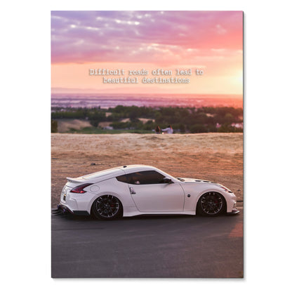 White Nissan 370z parked on road at sunset with motivational quote poster wall art.