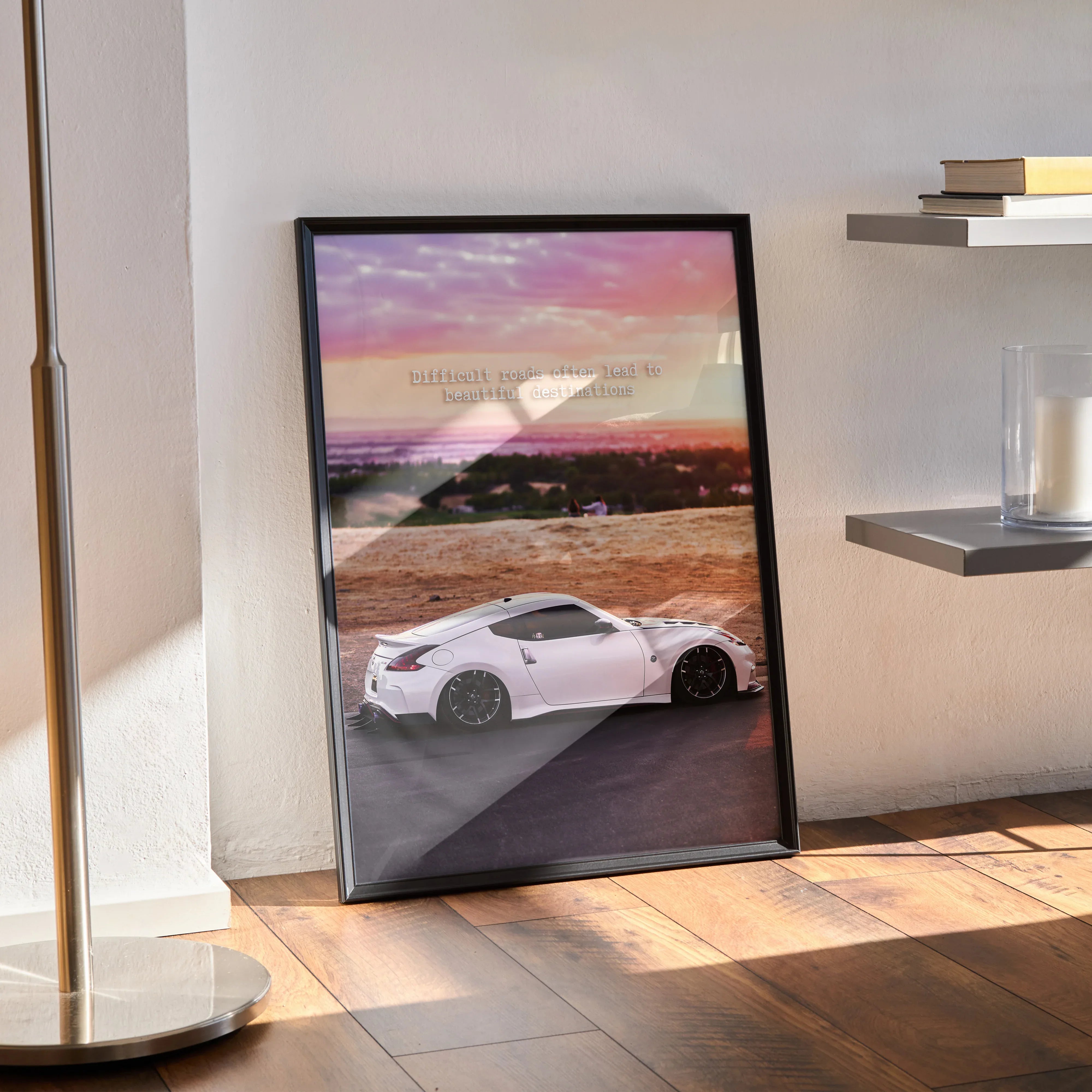 Nissan 370z poster wall art with white sports car and scenic sunset background in black frame.