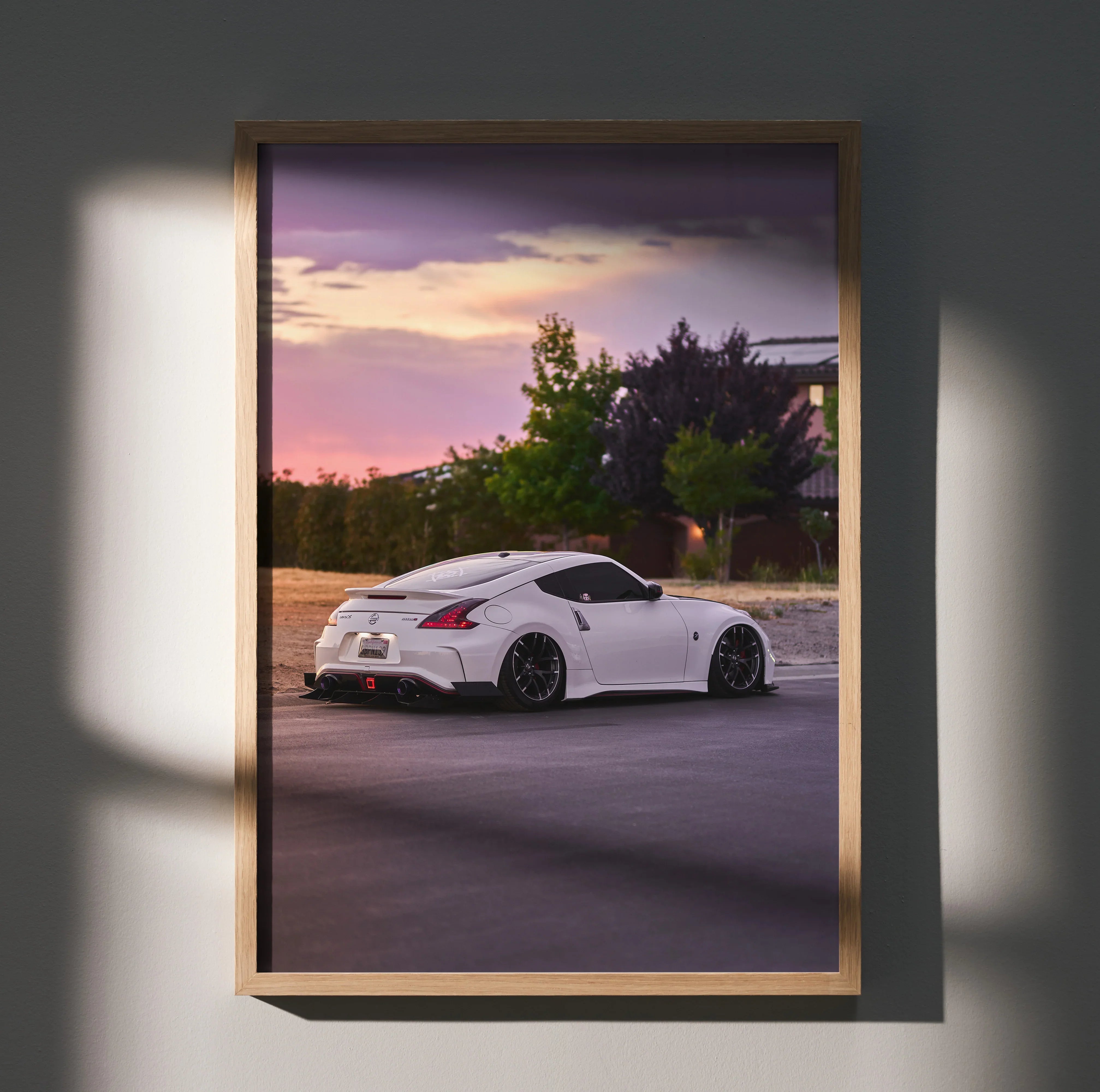 Nissan 370z poster wall art with white sports car at sunset and purple sky background.