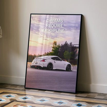 Motivational poster wall art featuring white Nissan 370z with "Dreams Require Discipline" text at sunset.