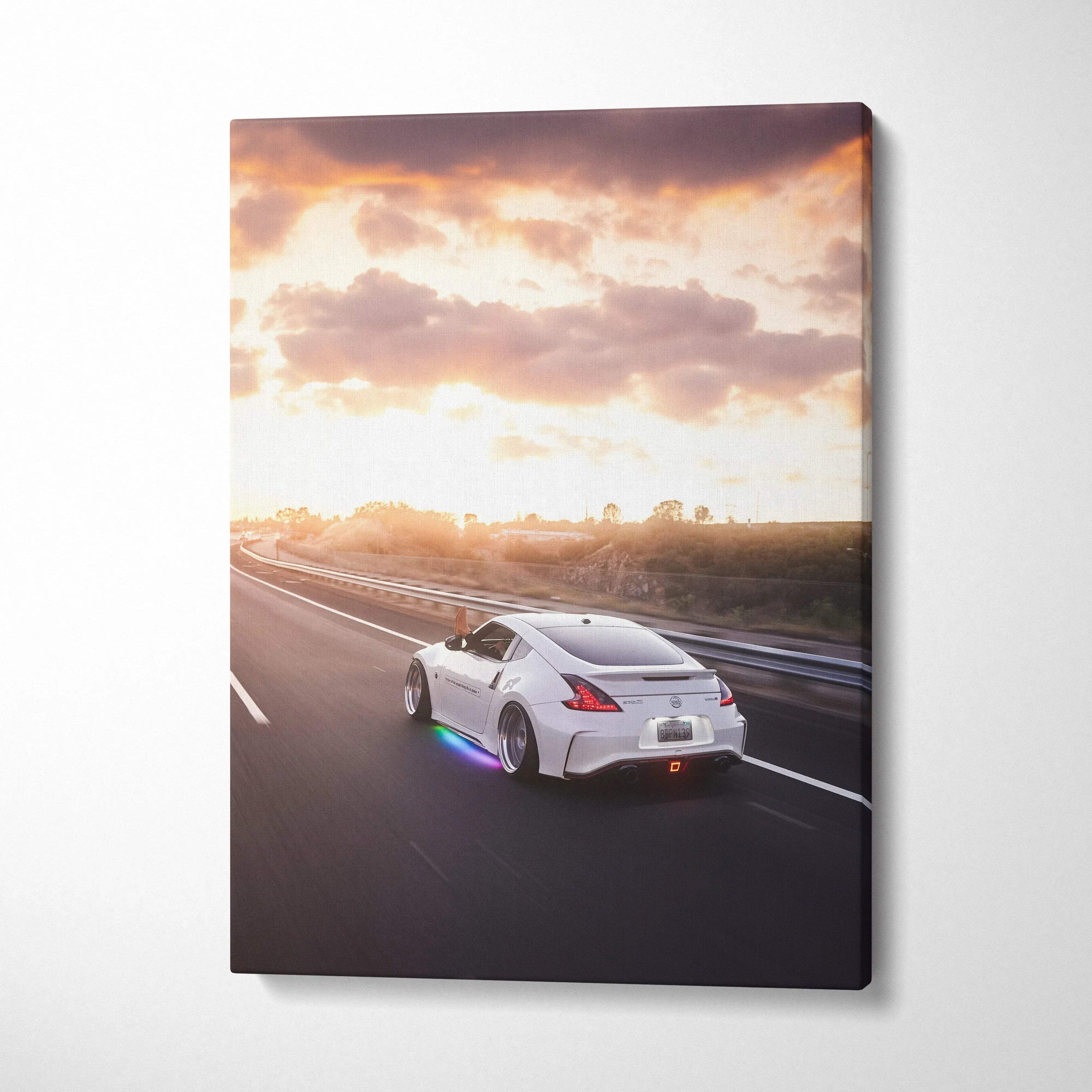 Nissan 370z driving on highway at sunset vertical canvas wall art.