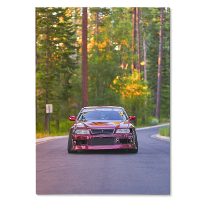Toyota Chaser JDM drift car poster on winding forest road, vibrant wall art in sunset light.